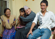 Joyful Homecoming: At home for the first time in nine years, Pastor Manja Tamang hugs his daughter, Tabita, with his wife, Rati, and son, Andreas.