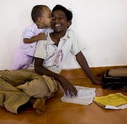 Parmesvaran's son (left) plays with his adopted older brother as he does his school work. Parmesvaran and his wife lost their three children in the 2004 tsunami. Soon after, they adopted several orphans from around their village. 