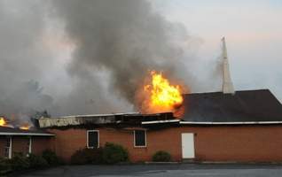 Flames shoot through the roof of the Centerville Church of God.